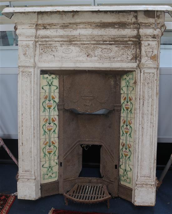 A late Victorian white painted cast iron chimney surround, inset ceramic tiles H.122cm